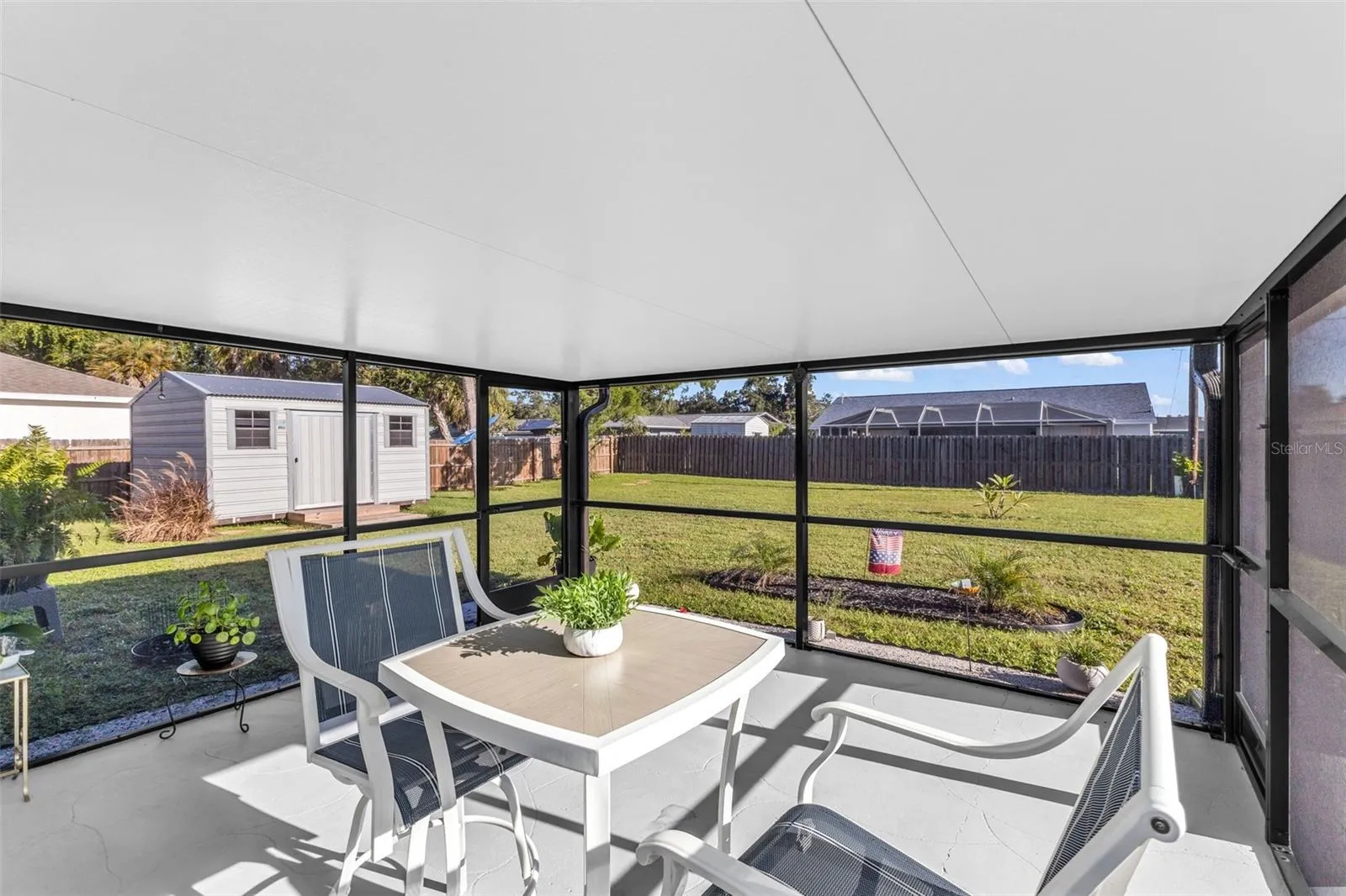 Screened lanai has exterior doors on left and right sides.