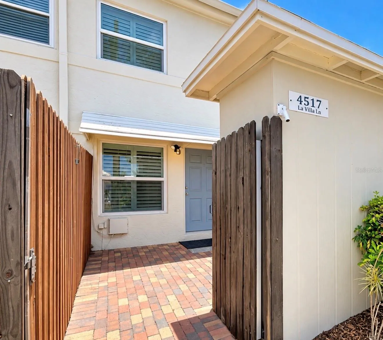 This is the entrance from the backside, where the parking spot is. You have a private patio area and storage area.