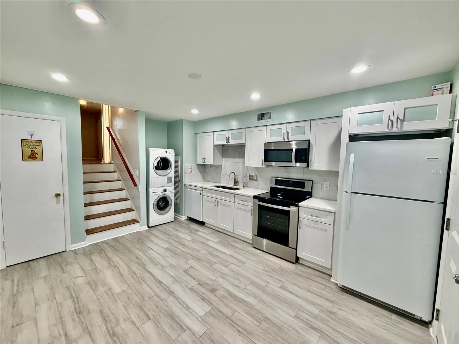 The kitchen is the first room when you enter from the backside. It is on the first level.