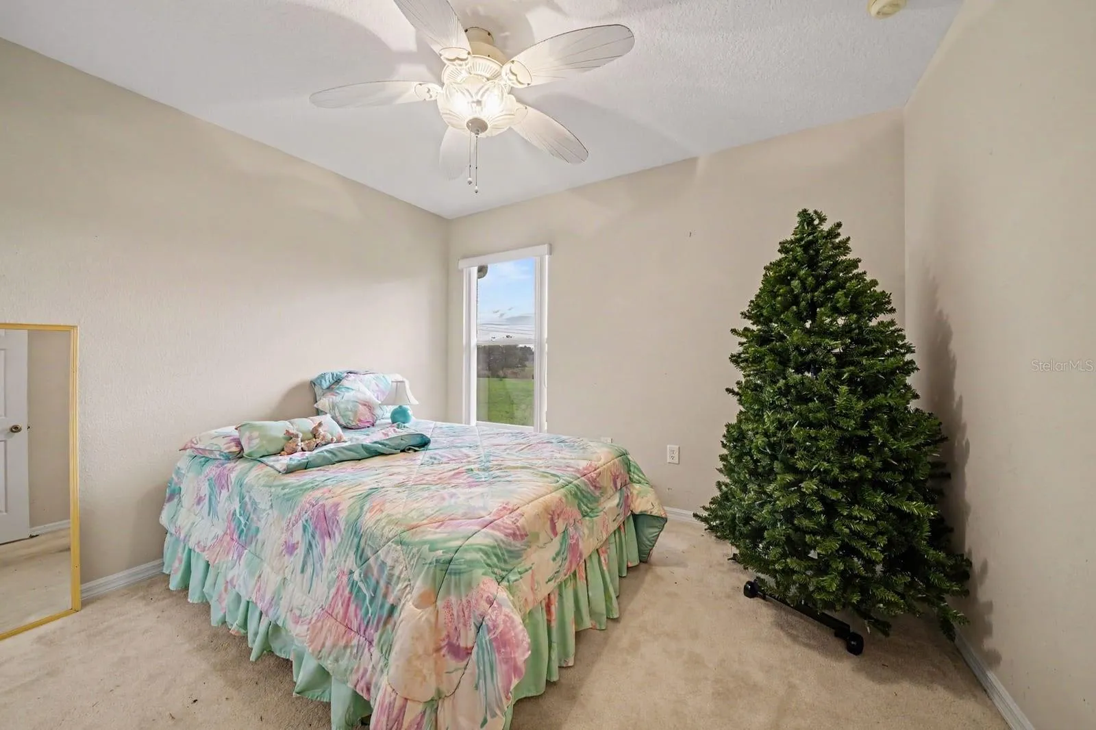 Spacious Bedroom with Bright Windows & Ceiling Fan