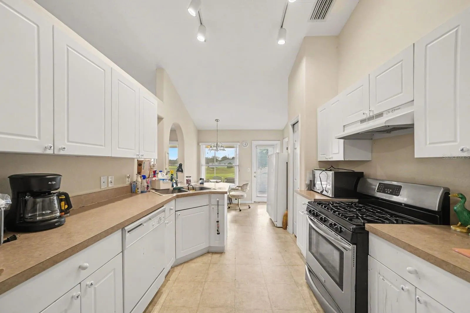 Galley Kitchen with White Cabinetry & Stainless Steel Appliances