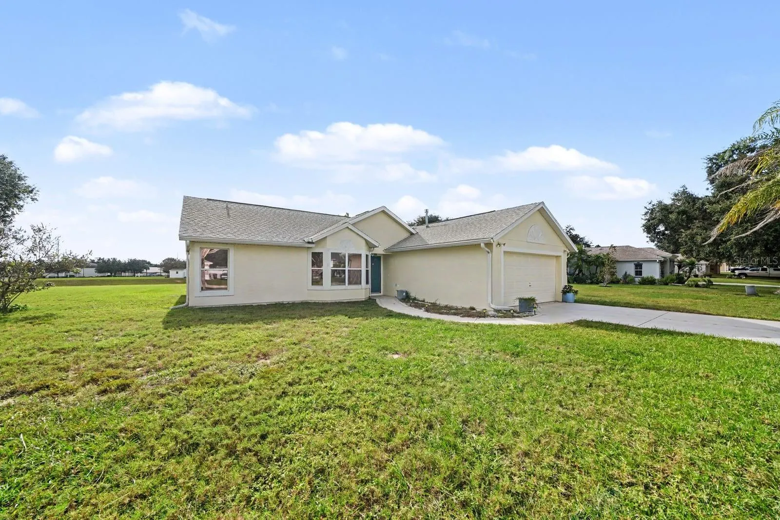 Single-story home with dual garage doors and manicured landscaping