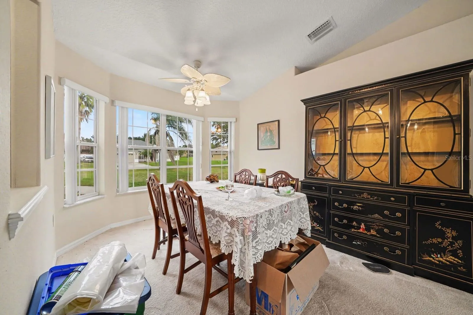 Elegant Dining Room with Bay Windows & Panoramic Lawn Views