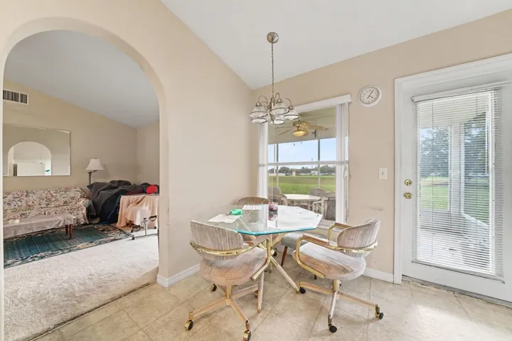 Bright Living Area with Arched Ceiling & Patio Access