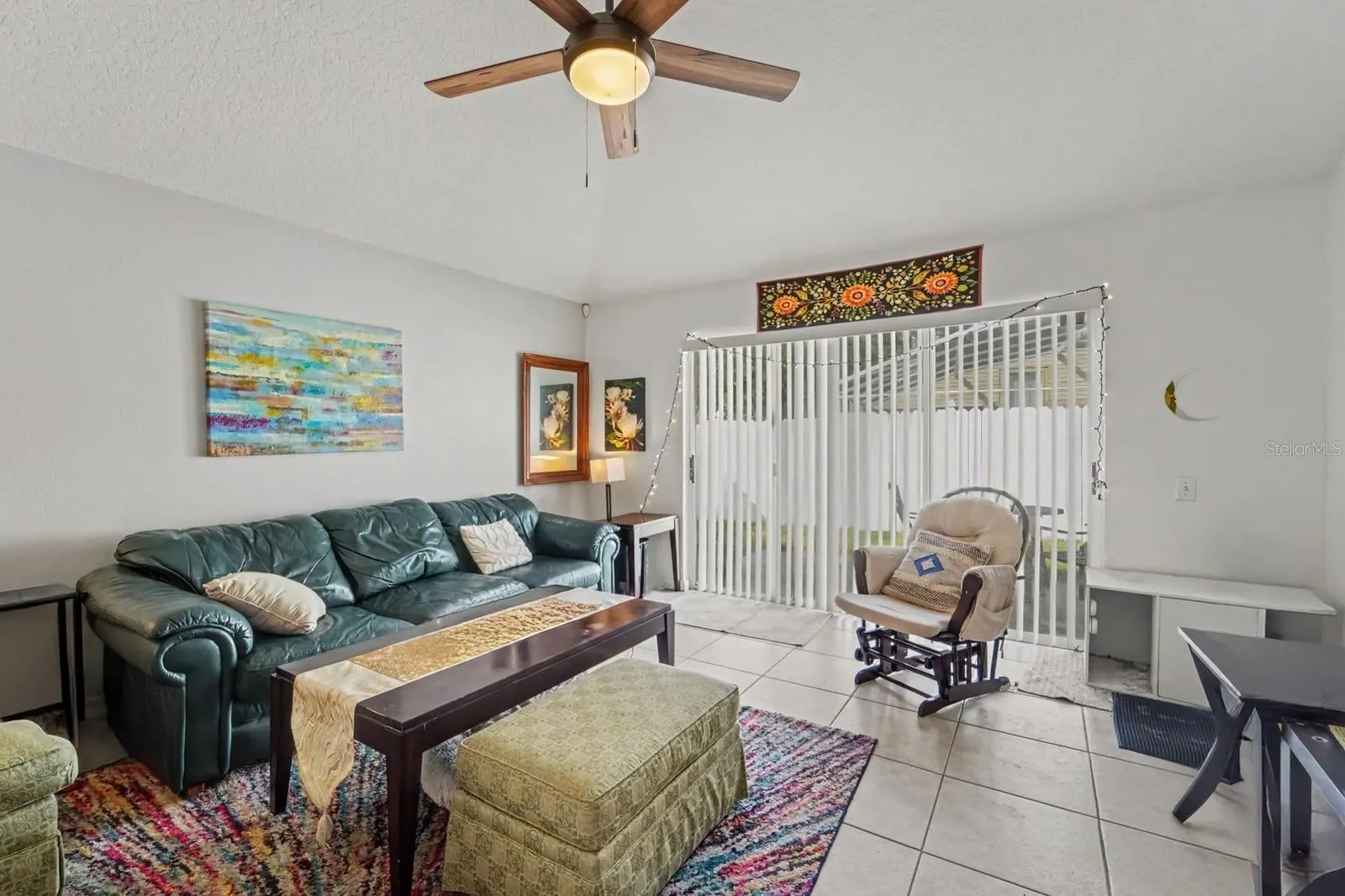 Open-concept living space with tile flooring and direct access to outdoor area
