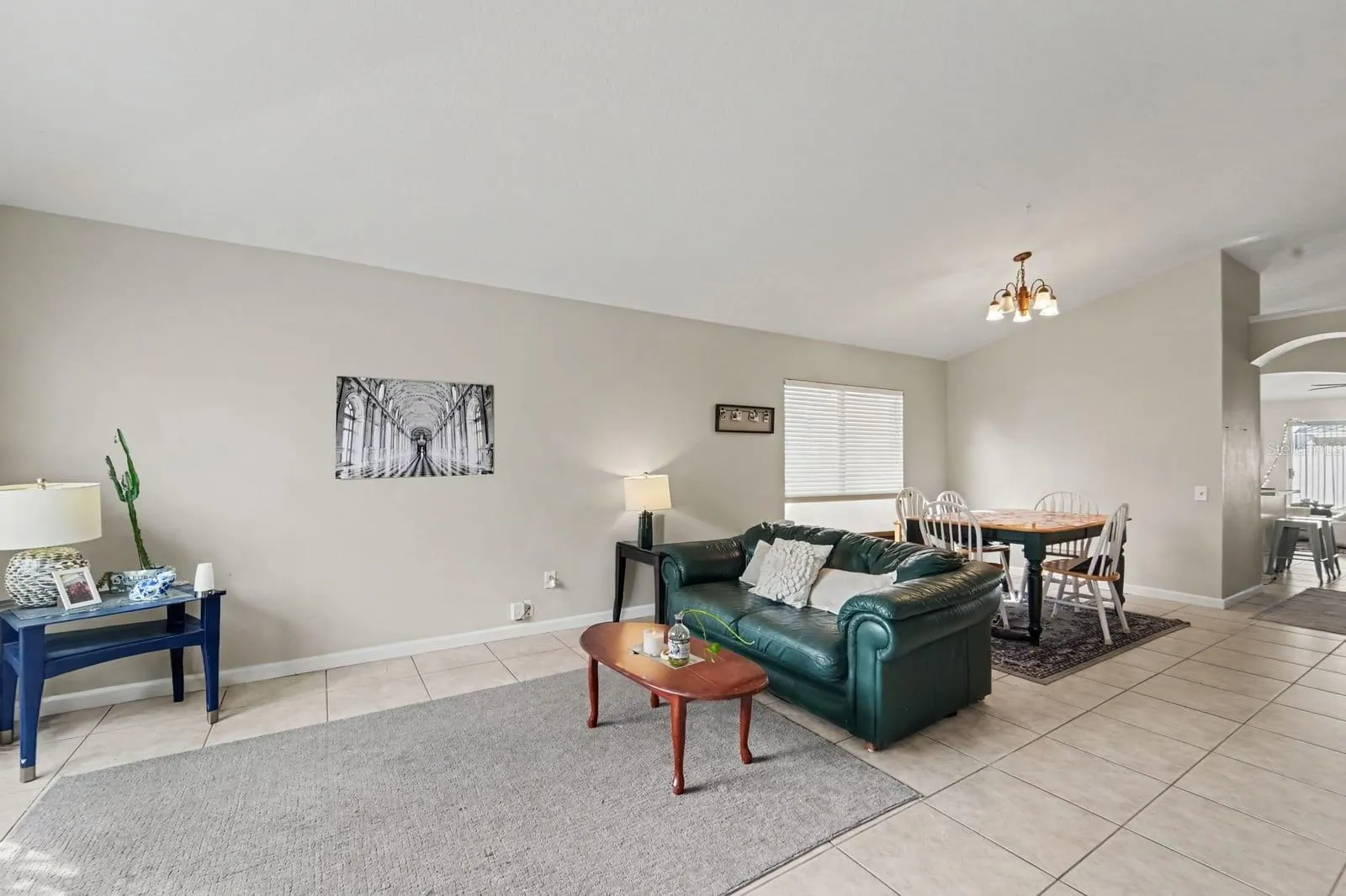 Open Living Areas with Tile Floors, Wood Coffee Table &amp; Abundant Natural Light