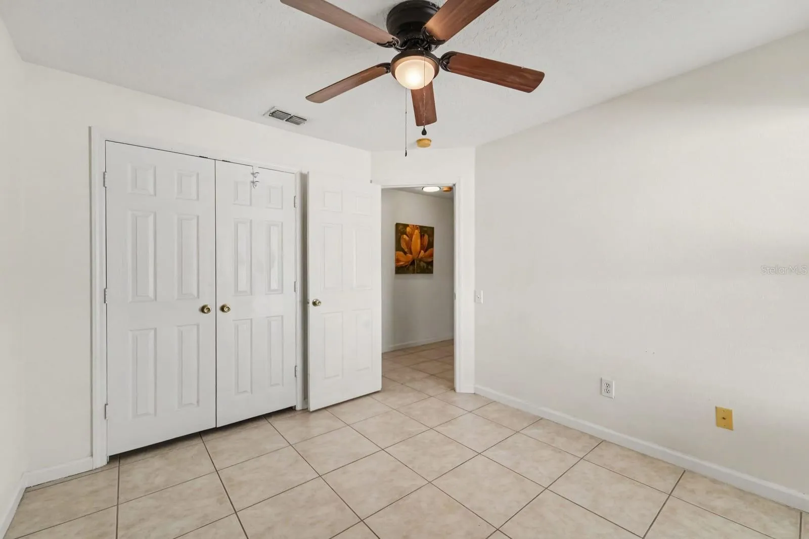 Bright Bedroom with Large Window Overlooking Yard &amp; Ceiling Fan with Light