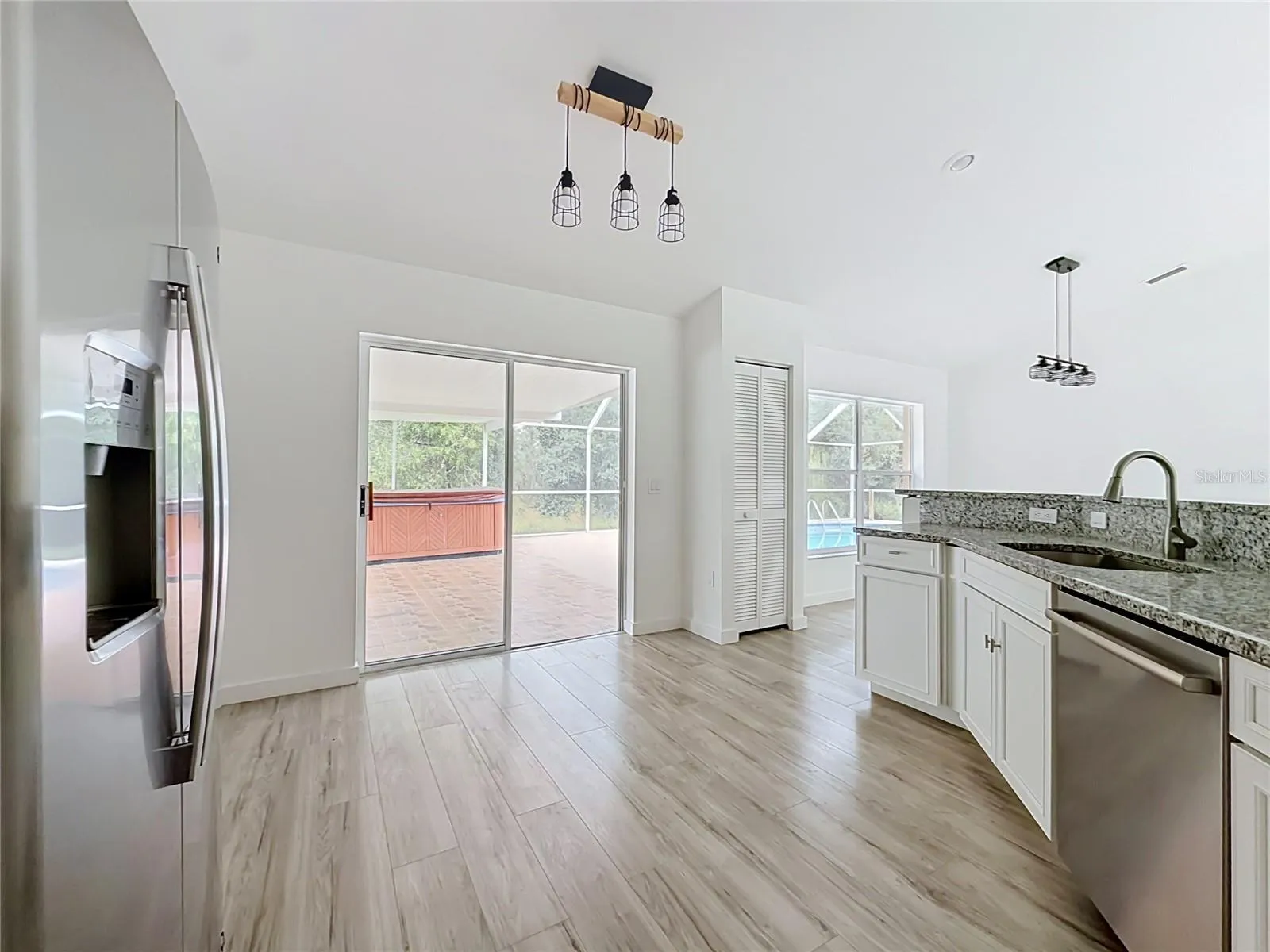 Sliding doors connect the kitchen to poolside living.