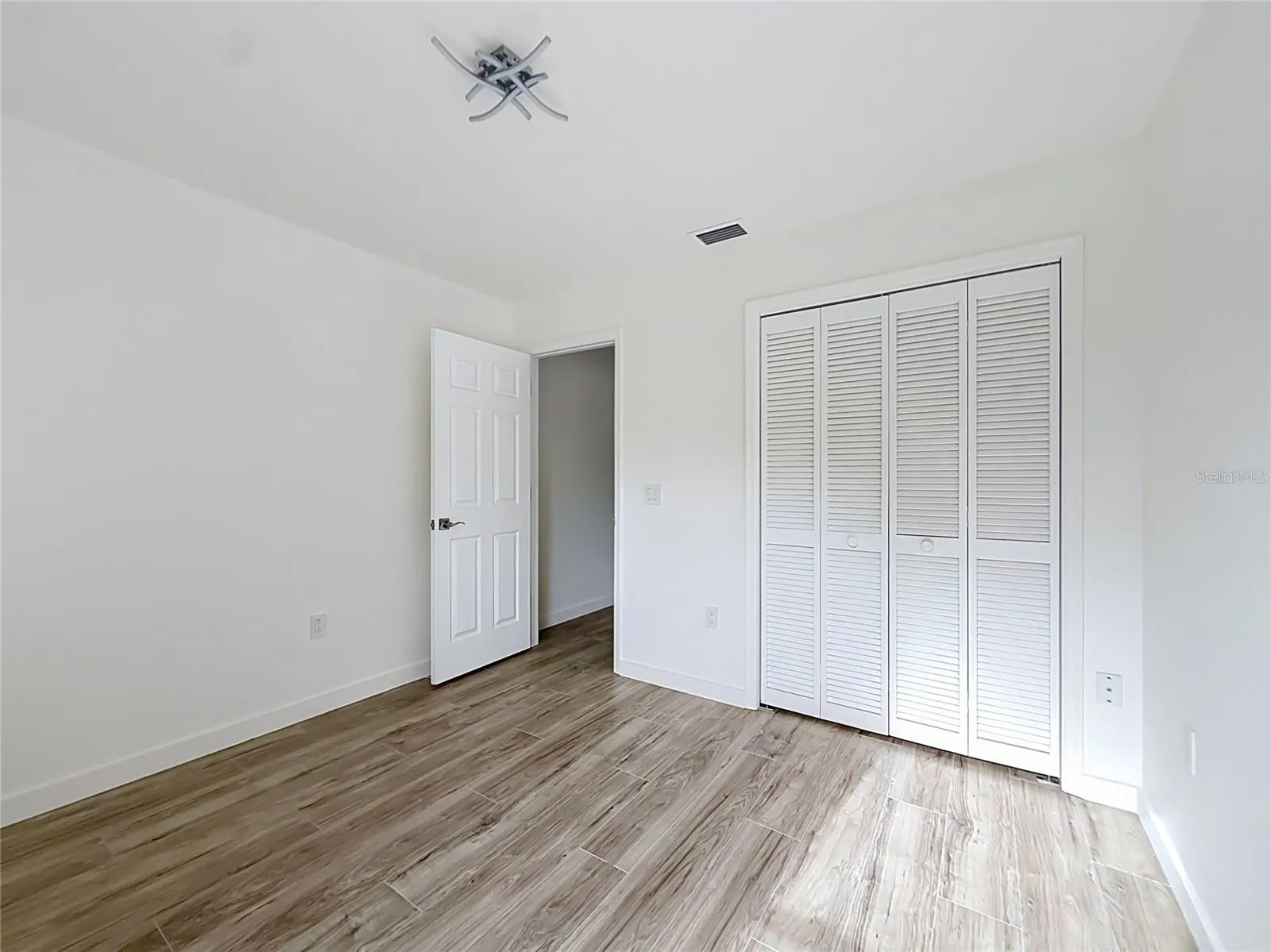Wood-look flooring creates a warm, inviting bedroom.