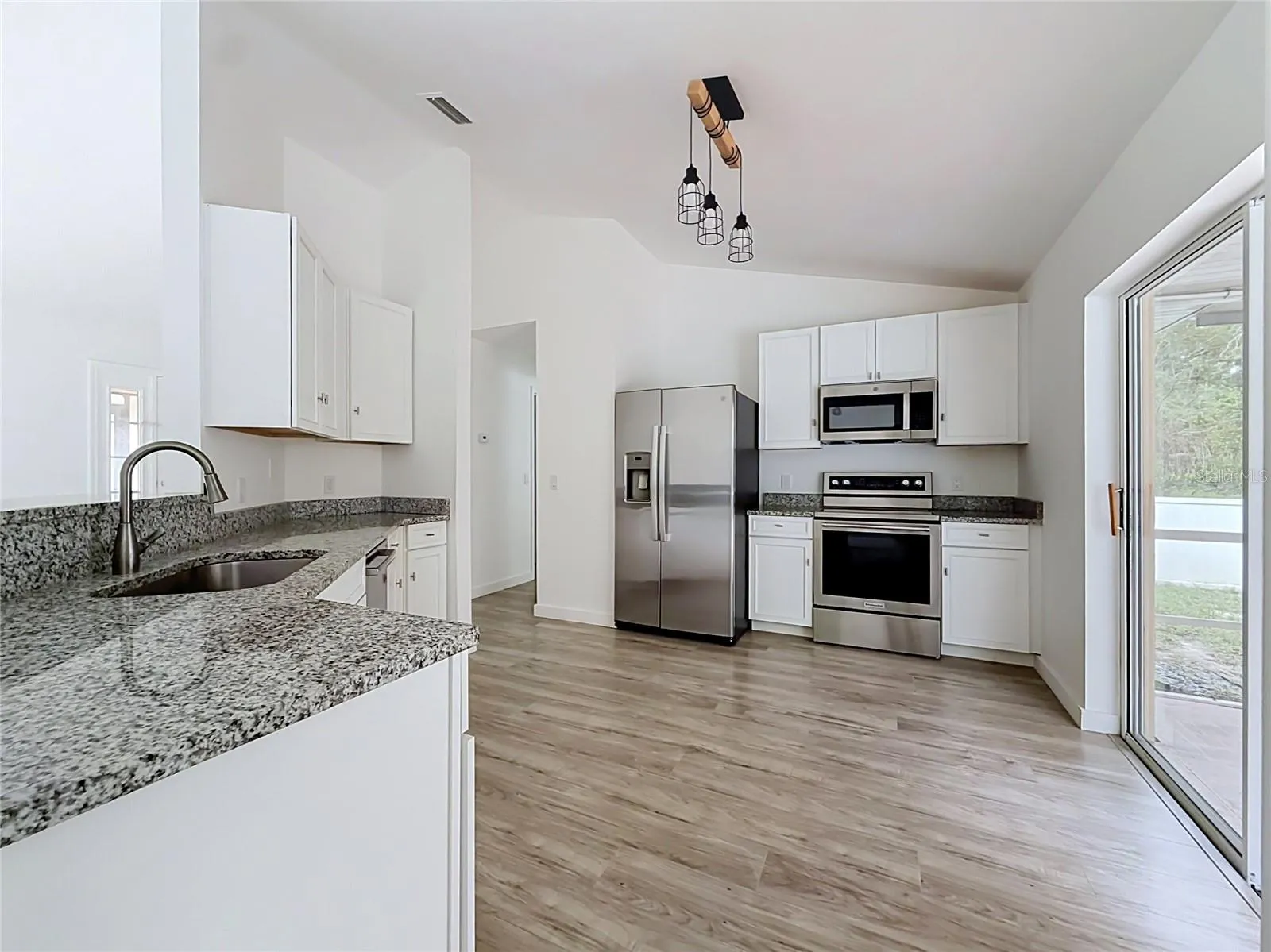 A bright kitchen with easy access to outdoor dining.