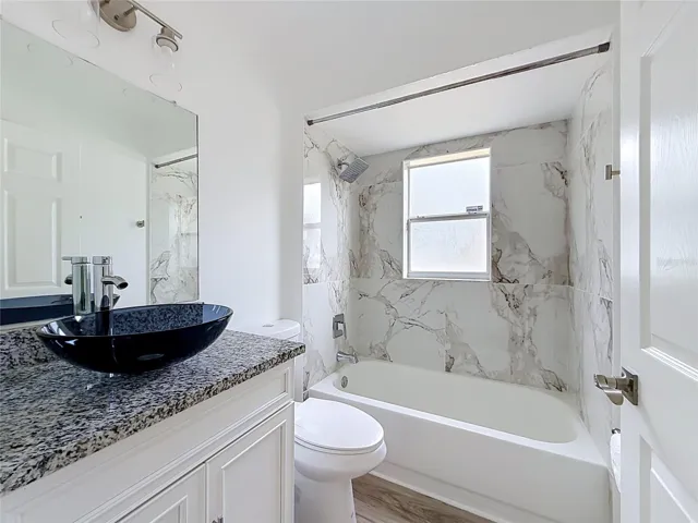 A vessel sink and tub/shower refresh the guest bath.