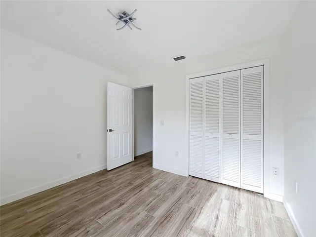 Wood-look flooring creates a warm, inviting bedroom.