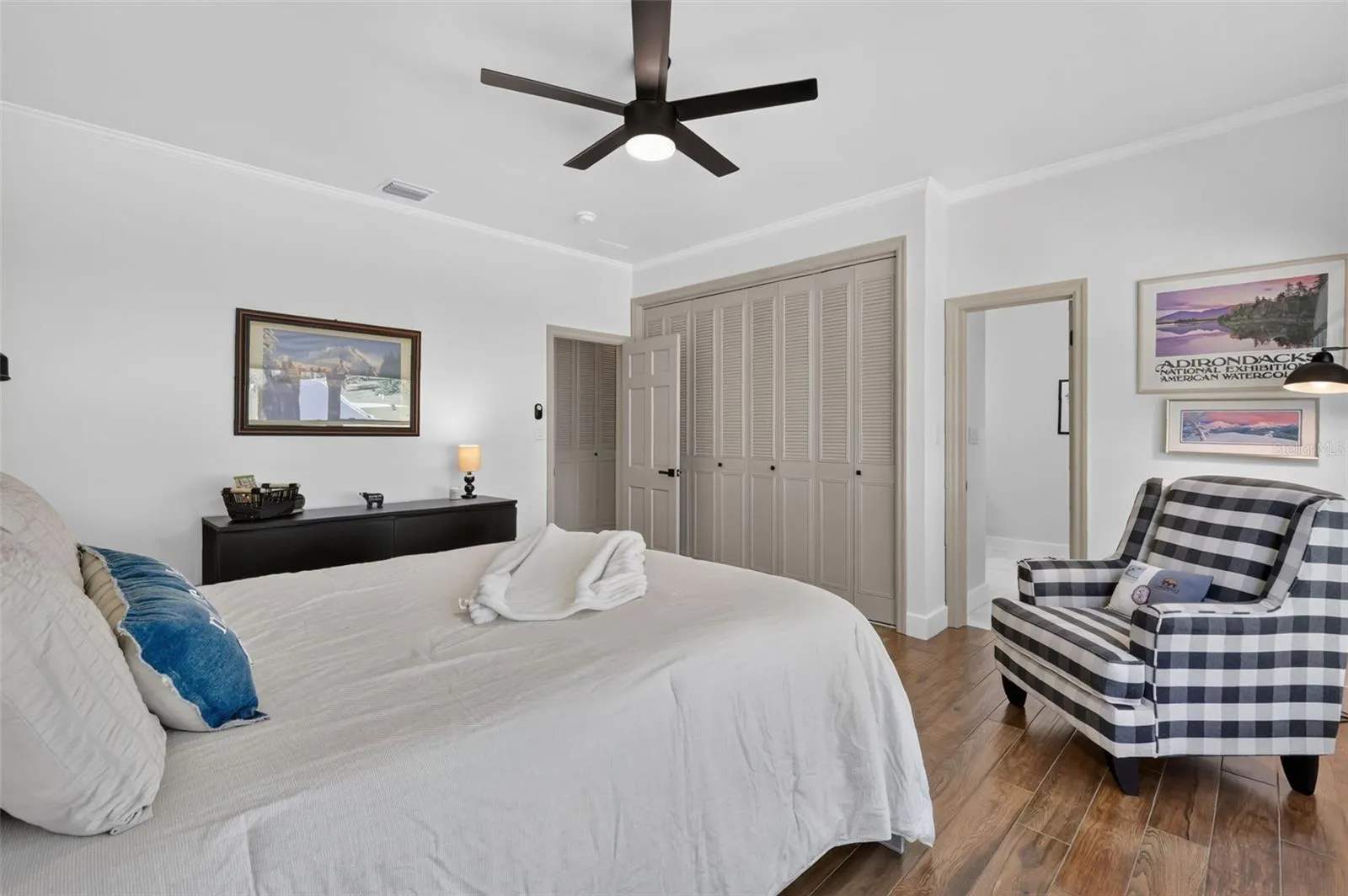 Bedroom 2 with wall of closets and entrance to en-suite/bathroom 2