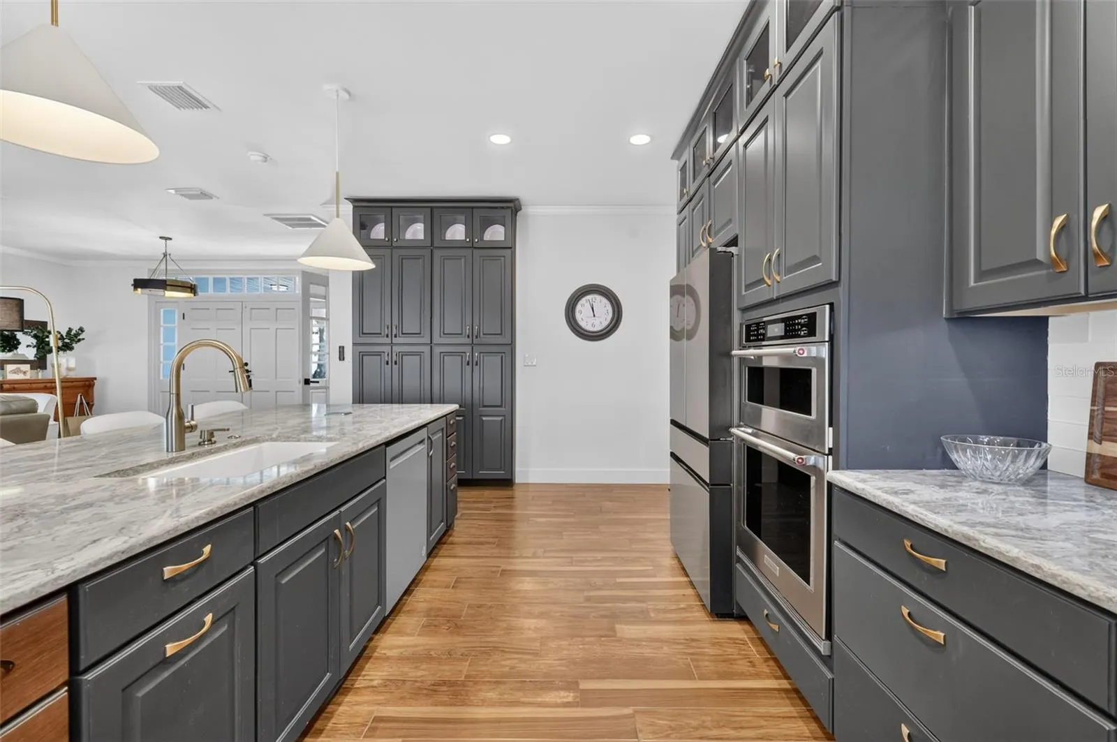 Custom cabinetry includes the built in pantry, double ovens, and a few surprises