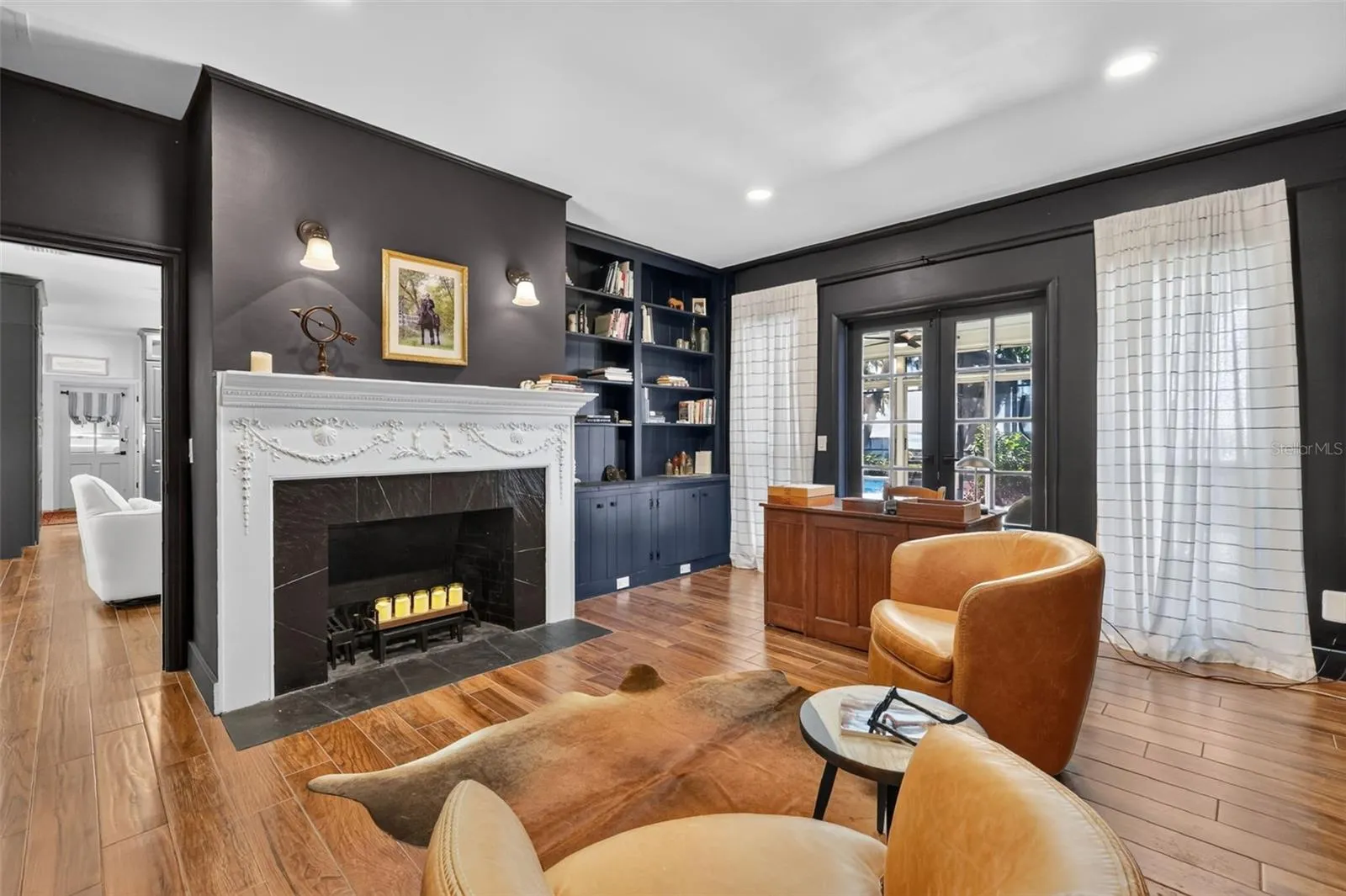 Wood burning fireplace, built in bookshelves, double French doors to the lanai/pool