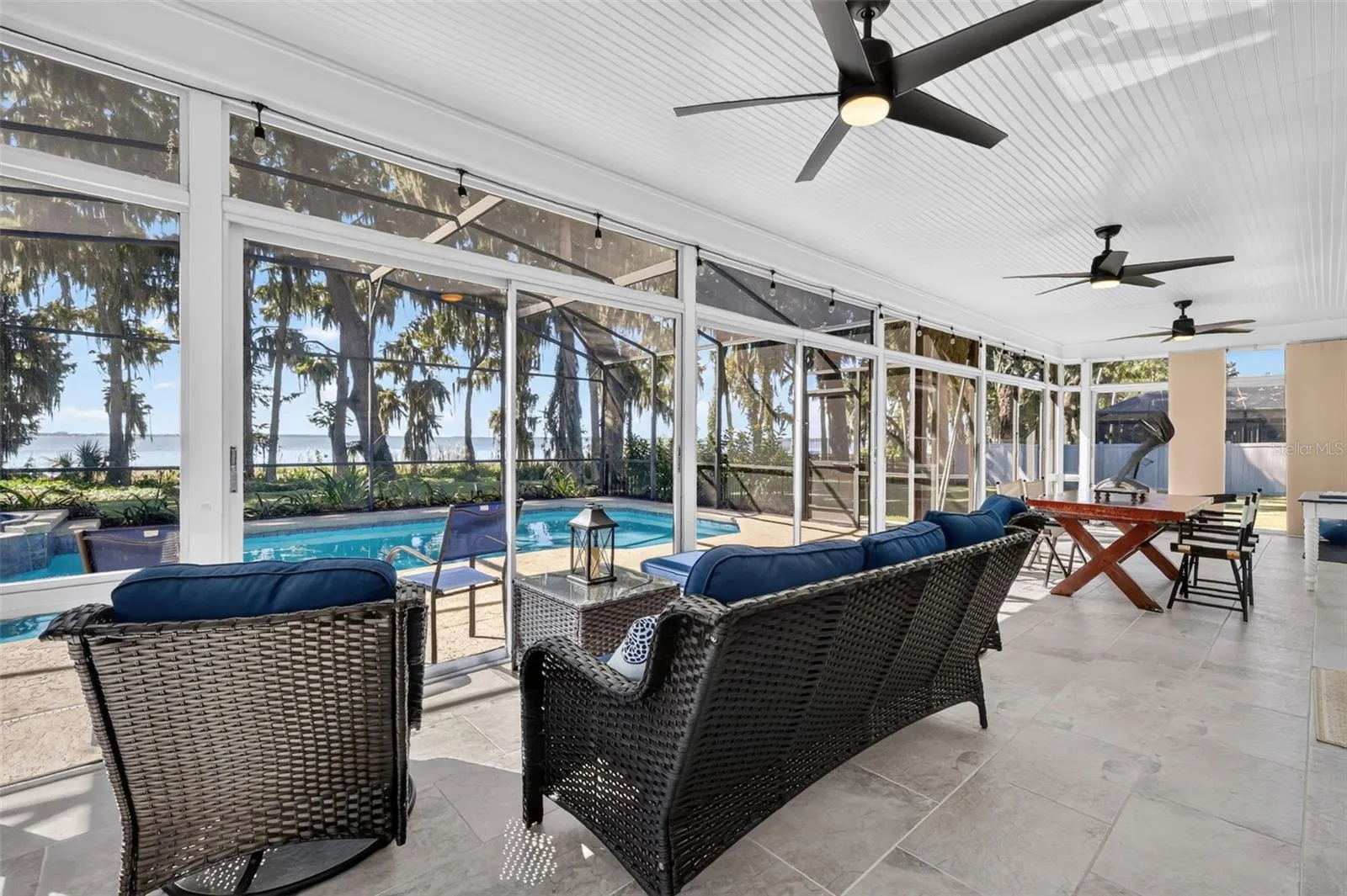 Tiled lanai, under heat and air. Wall of windows with pool and Lake Eustis views