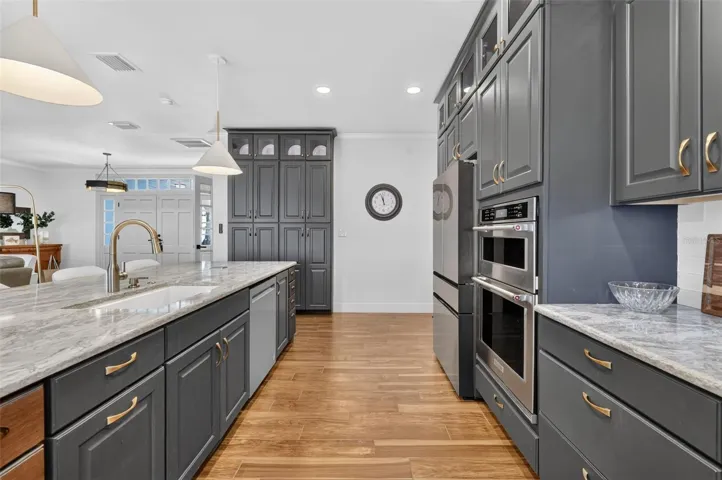 Custom cabinetry includes the built in pantry, double ovens, and a few surprises