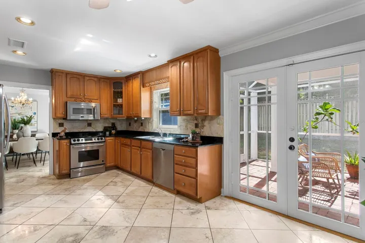 The closed lanai is just to the right of the kitchen and you can see the formal dining room.