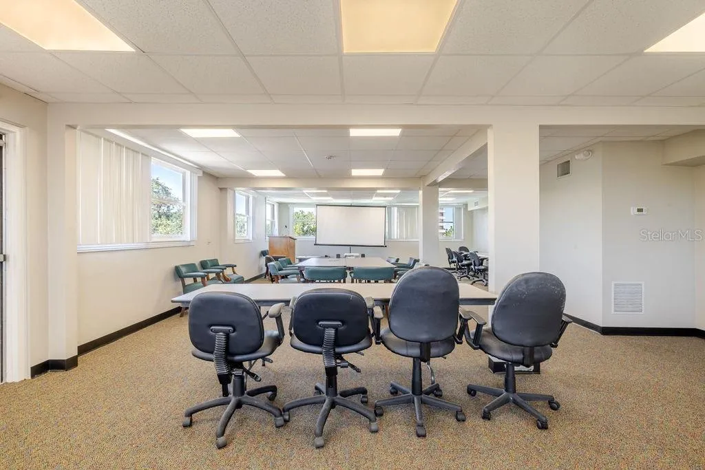 Third floor conference room and previous sleeping porch, with wrap around windows.