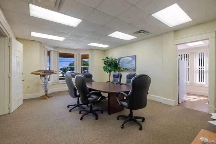 First floor conference room and previous living area with bay window overlooking the Halifax river.