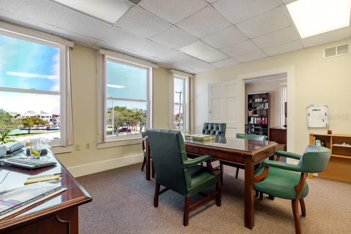 Second floor conference area with oversized historic windows.