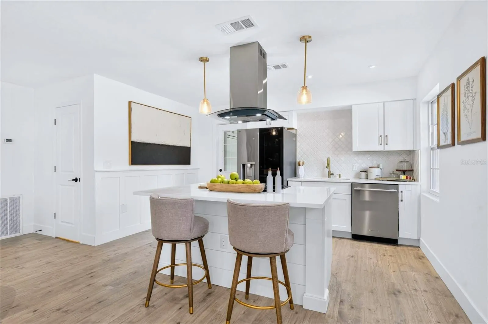 the Kitchen boasts a island stove with a vent hood and custom columns for the island ends.