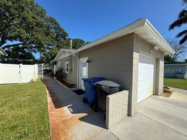 Front view of west side of house with sidewalk to back of residence