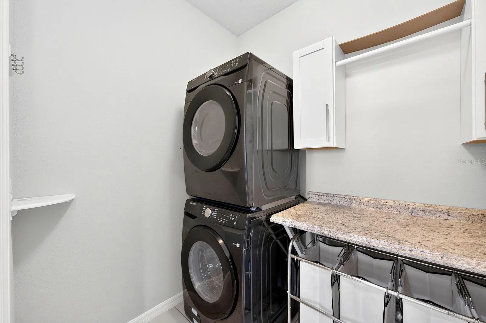 A DEDICATED LAUNDRY ROOM on the first floor includes a GRANITE FOLDING COUNTER and cabinetry to keep everything organized.
