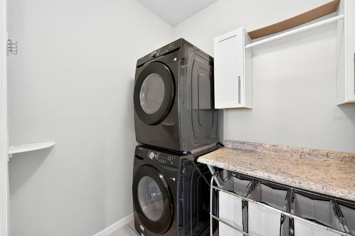A DEDICATED LAUNDRY ROOM on the first floor includes a GRANITE FOLDING COUNTER and cabinetry to keep everything organized.