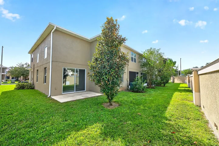 Sliding glass doors extend the living space outdoors to the back patio overlooking a peaceful GREEN SPACE—a wonderful spot to enjoy your morning coffee or unwind at the end of the day.