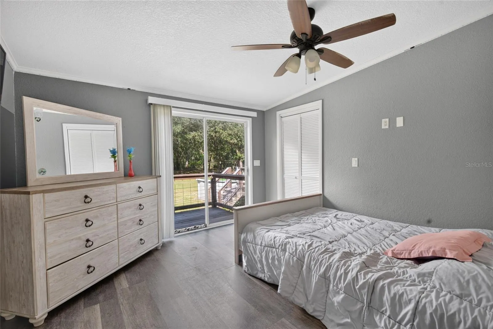 Bedroom four, that has sliding doors to the rear pf the home overlooking the large property