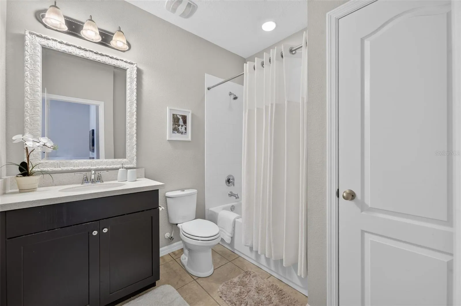 Full bathroom is adjacent to secondary bedroom on the top floor and features a tub/shower combination