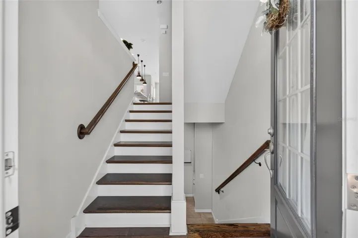 Stairwell upon entry; covered with hardwood flooring on all 3 stairways; short flight up goes to main living area; one short flight down there's a bedroom, full bath and garage entry. Top level has 2 Bedrooms, 2 full baths and a laundry room