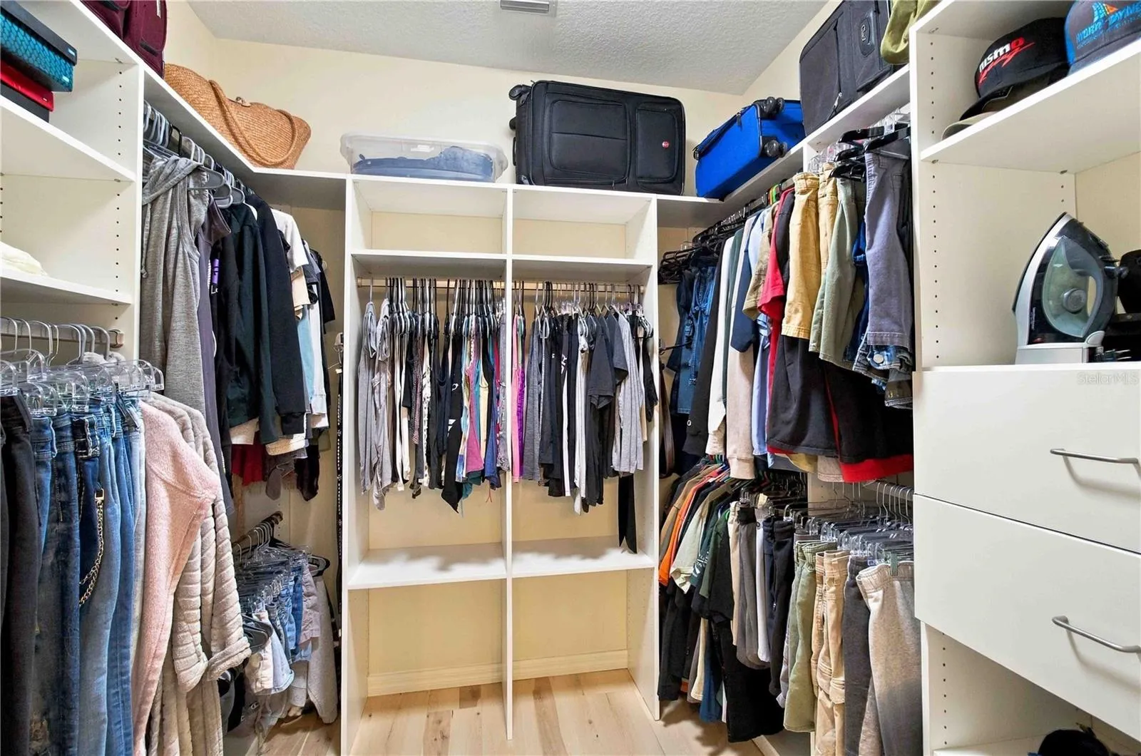 Primary walk-in closet with custom shelving