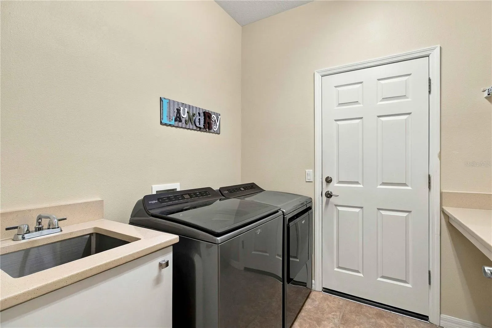 Inside laundry room with 2024 washer and dryer