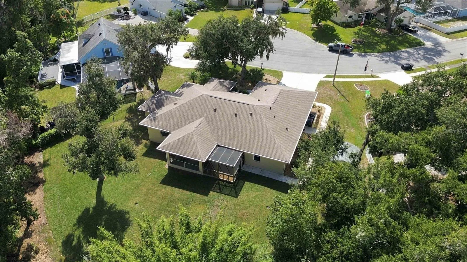 Aerial view of the half-acre lot backing to wooded preserve