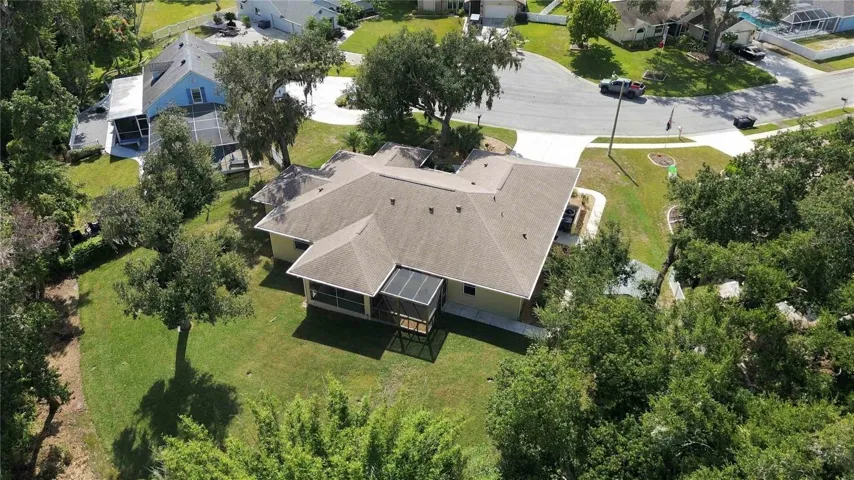 Aerial view of the half-acre lot backing to wooded preserve