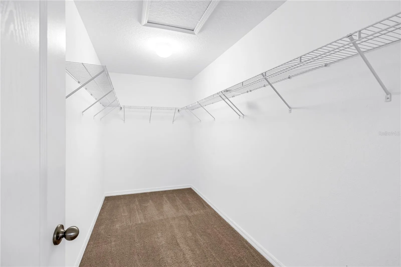 Primary bedroom walk in closet