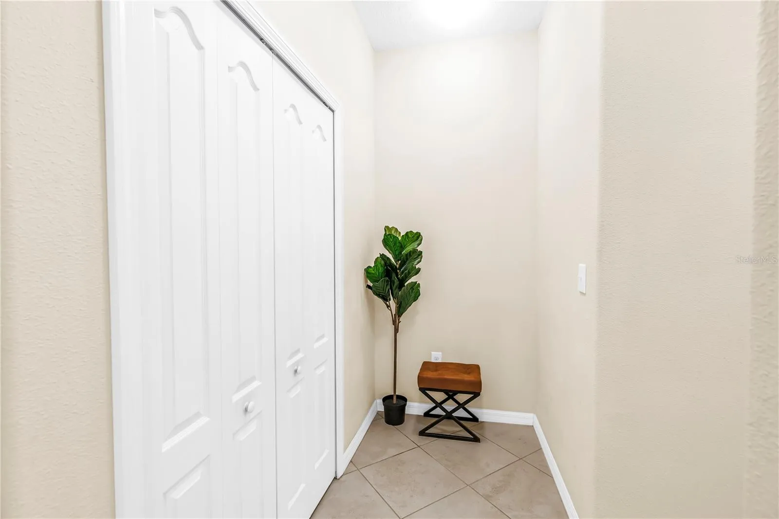 Hall and closet off of kitchen leading to half bath and garage