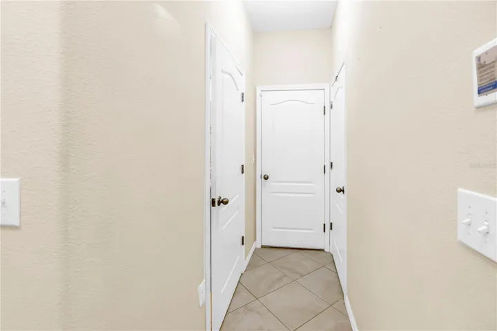 Upstairs hallway to spare bedrooms, full bathroom, and laundry room