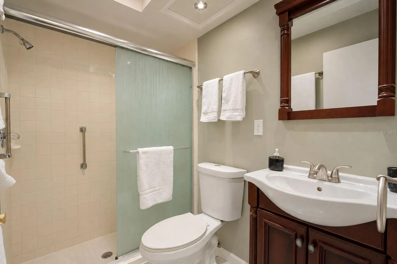 Private en-suite bath and glass enclosed walk-in shower~