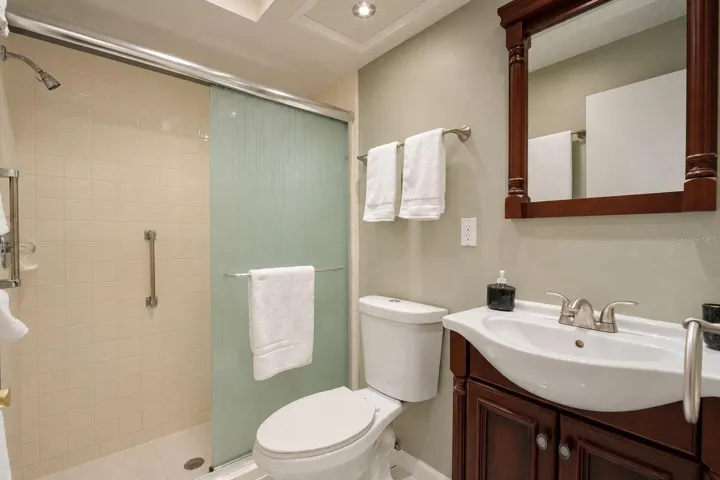 Private en-suite bath and glass enclosed walk-in shower~