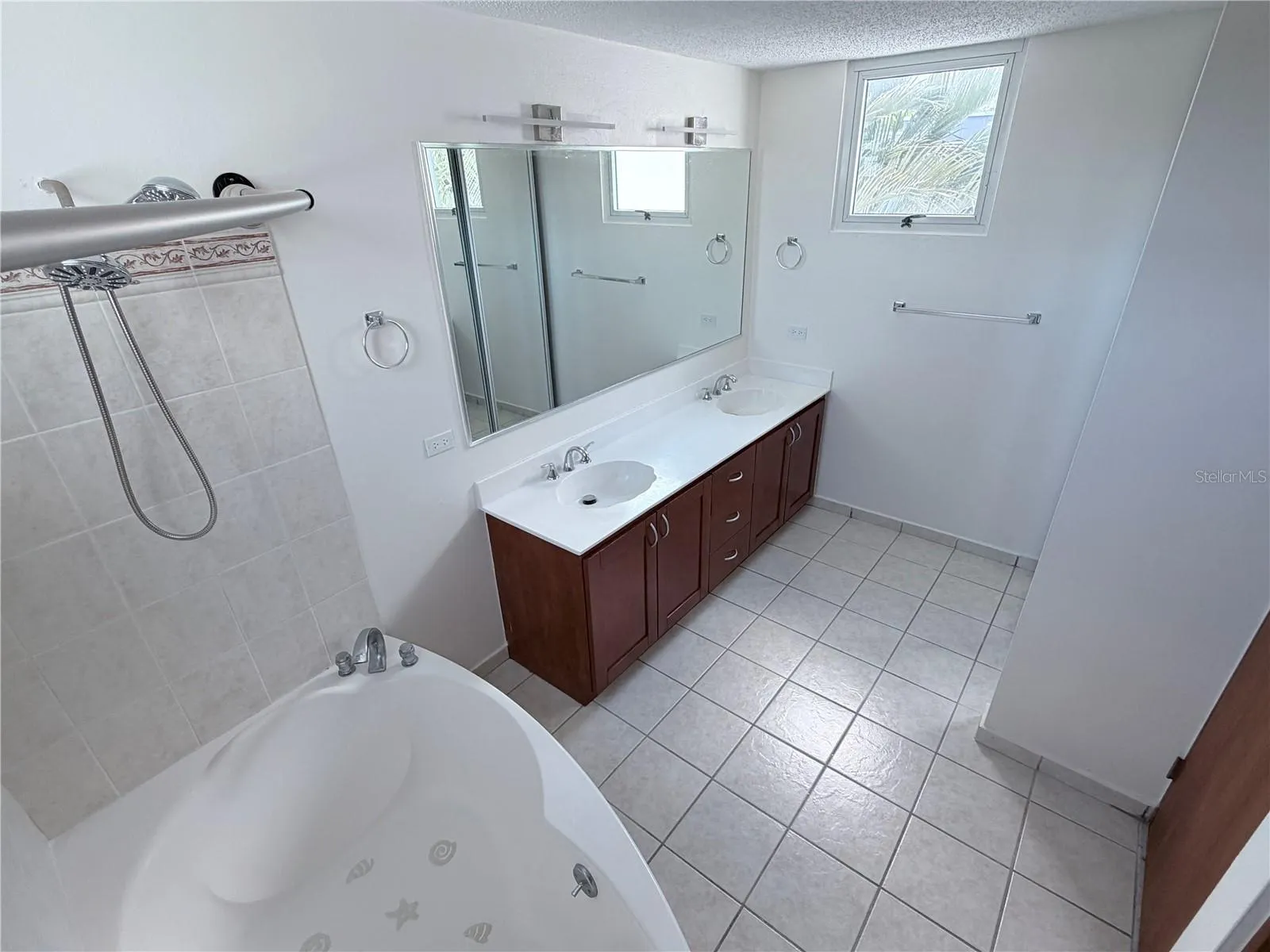 master bathroom with his and hers and bathtub