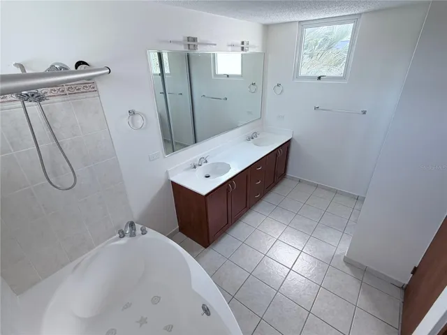 master bathroom with his and hers and bathtub