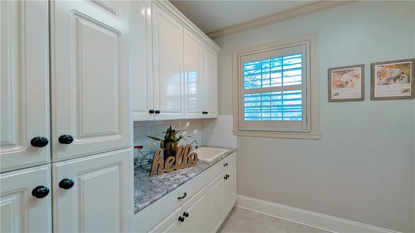 Laundry area with lots of counter space and a sink!
