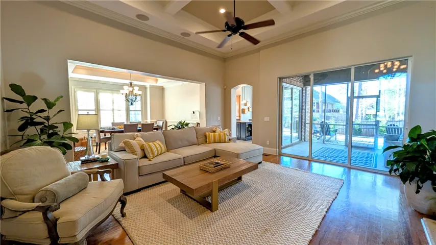 Great room with dining, kitchen, & screen porch in background