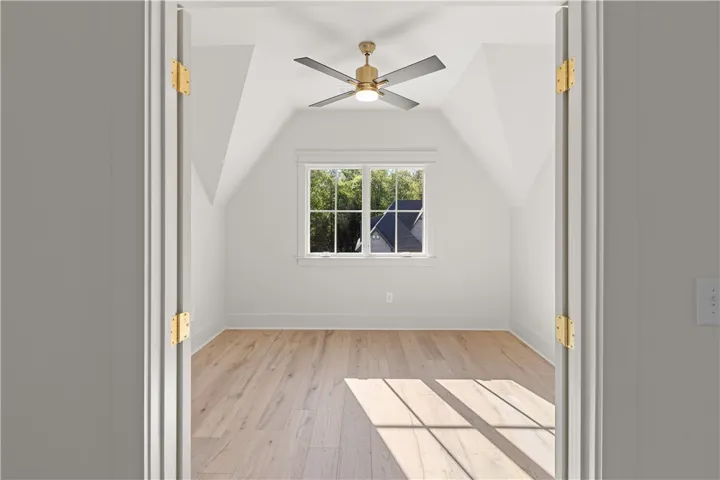 This spacious room offers abundant natural light and vaulted ceilings, perfect for a cozy retreat.