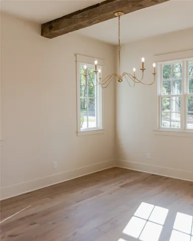 Sun-drenched room with natural light and rustic beam accent.