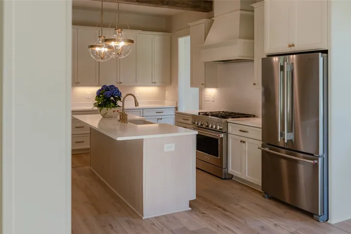 This bright kitchen features modern appliances and a central island, perfect for culinary endeavors.
