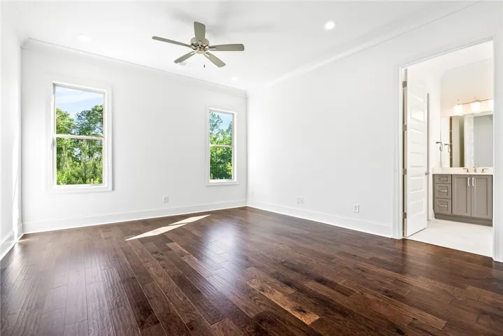 Bright and airy room with polished hardwood floors and abundant natural light.